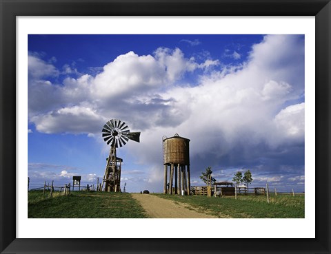 Framed Low angle view of a water tower and an industrial windmill, 1880 Town, South Dakota, USA Print