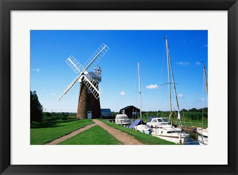 Framed Boat moored near a traditional windmill, River Ant, Norfolk Broads, Norfolk, England Print