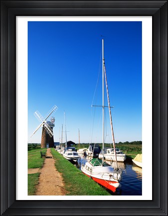 Framed Boats moored near a traditional windmill, Horsey Windpump, Horsey, Norfolk Broads, Norfolk, England Print
