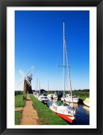 Framed Boats moored near a traditional windmill, Horsey Windpump, Horsey, Norfolk Broads, Norfolk, England Print