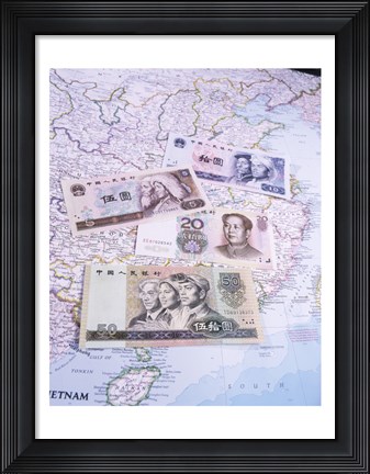 Framed Close-up of yuan notes on a map Print