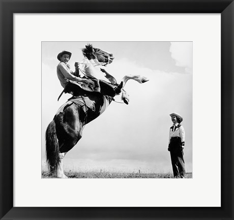 Framed Low angle view of a cowboy riding a bucking horse Print