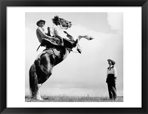 Framed Low angle view of a cowboy riding a bucking horse Print