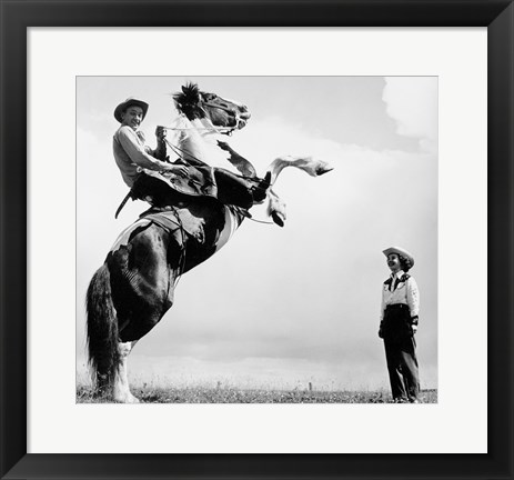 Framed Low angle view of a cowboy riding a bucking horse Print