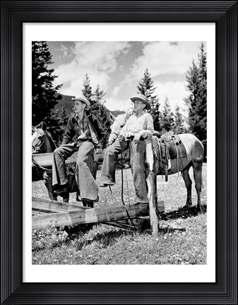 Framed Teenage cowboys sitting on rail fence Print