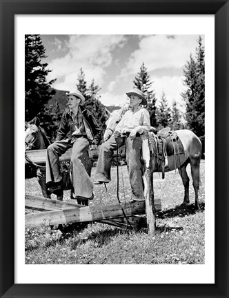 Framed Teenage cowboys sitting on rail fence Print