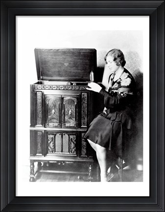 Framed Young woman sitting beside an RCA Radio-Phonograph and Home Recorder Print