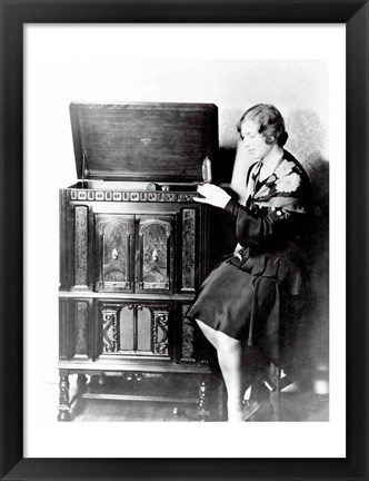 Framed Young woman sitting beside an RCA Radio-Phonograph and Home Recorder Print