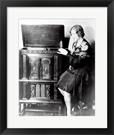 Framed Young woman sitting beside an RCA Radio-Phonograph and Home Recorder Print