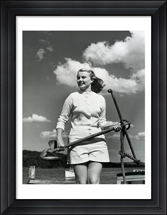 Framed Young woman standing on boat, holding anchor Print