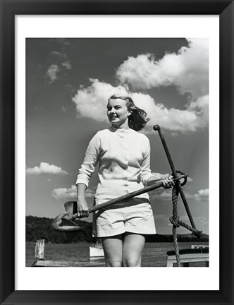 Framed Young woman standing on boat, holding anchor Print