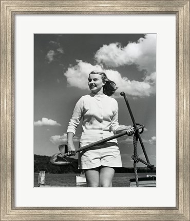 Framed Young woman standing on boat, holding anchor Print