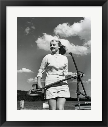 Framed Young woman standing on boat, holding anchor Print