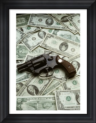 Framed Close-up of a handgun with paper currency Print