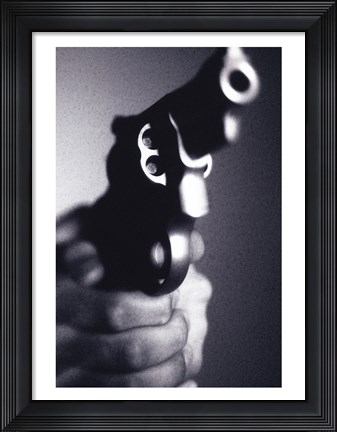 Framed Close-up of a person holding a handgun Print