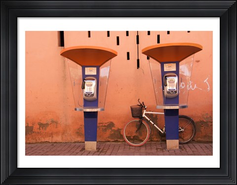 Framed Public telephone booths in front of a wall, Morocco Print