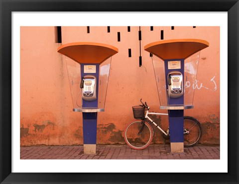 Framed Public telephone booths in front of a wall, Morocco Print