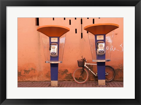 Framed Public telephone booths in front of a wall, Morocco Print