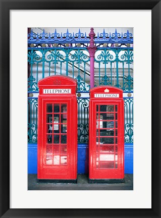 Framed Two telephone booths near a grille, London, England Print