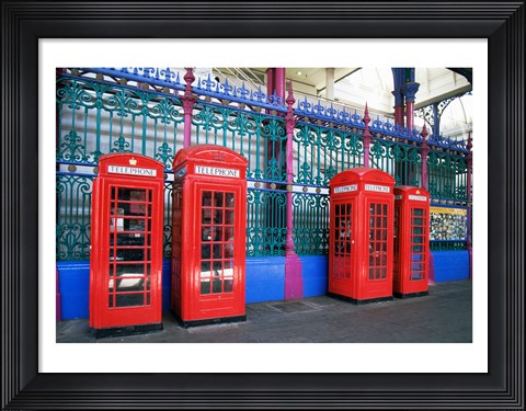 Framed Four telephone booths near a grille, London, England Print