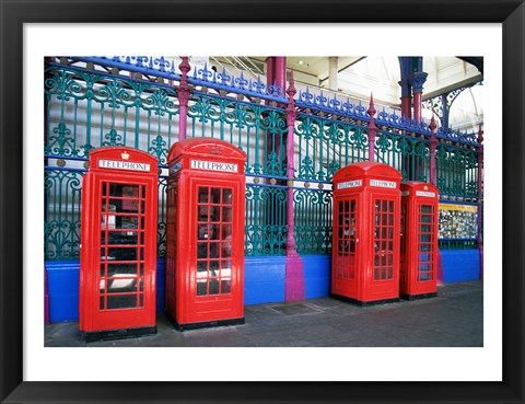 Framed Four telephone booths near a grille, London, England Print