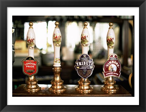 Framed Close-up of beer tap handles in a bar, London, England Print