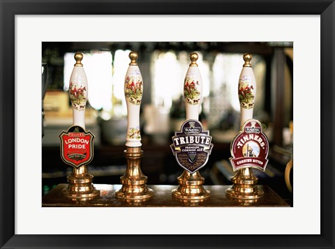 Framed Close-up of beer tap handles in a bar, London, England Print