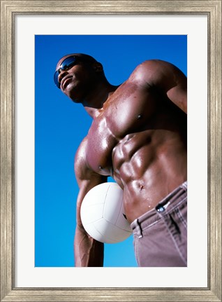 Framed Low angle view of a young man holding a volleyball Print