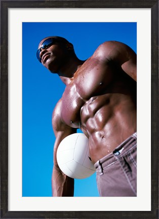 Framed Low angle view of a young man holding a volleyball Print
