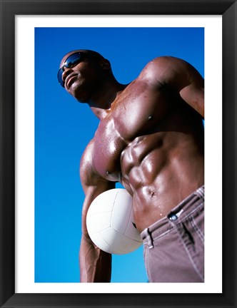 Framed Low angle view of a young man holding a volleyball Print