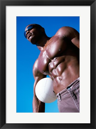 Framed Low angle view of a young man holding a volleyball Print