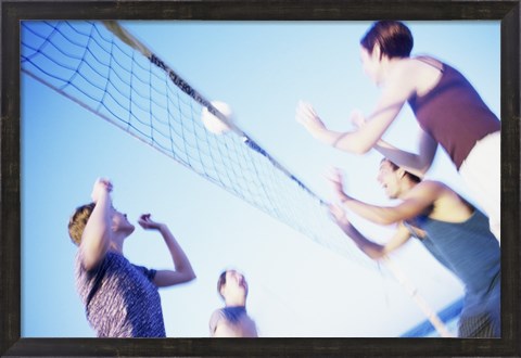 Framed Low angle view of two young couples playing beach volleyball Print