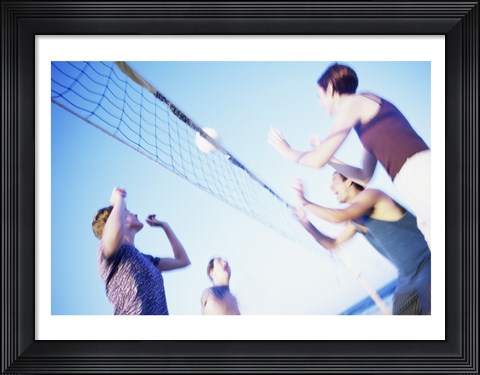 Framed Low angle view of two young couples playing beach volleyball Print