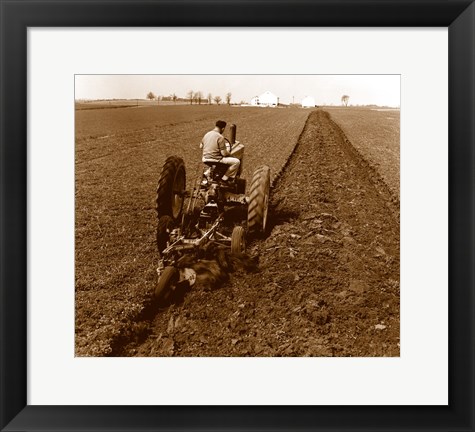 Framed USA, Pennsylvania, Farmer on Tractor Plowing Field Print