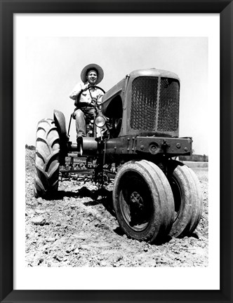 Framed Farmer Sitting on a Tractor in a Field Print