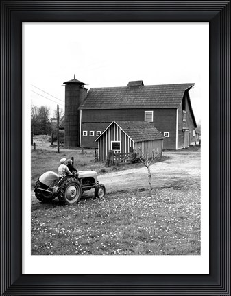 Framed Man with a Boy Riding a Tractor in a Field Print