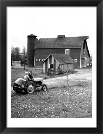 Framed Man with a Boy Riding a Tractor in a Field Print