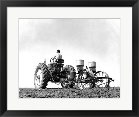 Framed Low Angle View of a Farmer Planting Corn with a Tractor in a Field Print