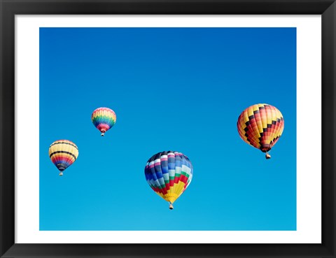 Framed 4 Rainbow Hot Air Balloons in the Bright Blue Sky Print