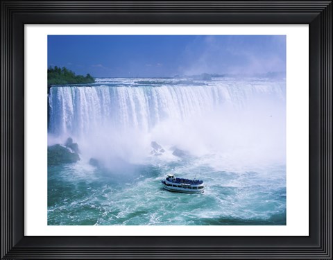 Framed High angle view of a tourboat in front of a waterfall, Niagara Falls, Ontario, Canada Print