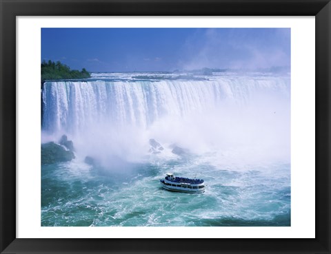 Framed High angle view of a tourboat in front of a waterfall, Niagara Falls, Ontario, Canada Print