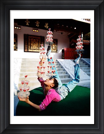 Framed Acrobat balancing glasses, Shanghai, China Print