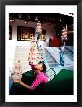 Framed Acrobat balancing glasses, Shanghai, China Print