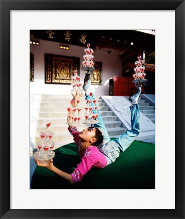 Framed Acrobat balancing glasses, Shanghai, China Print