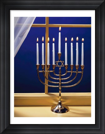Framed Close-up of burning candles on a menorah at a window Print