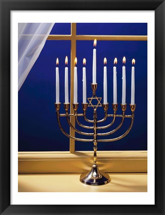 Framed Close-up of burning candles on a menorah at a window Print