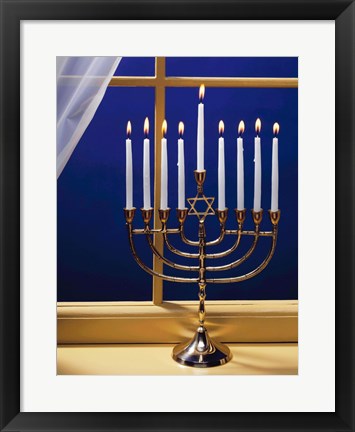 Framed Close-up of burning candles on a menorah at a window Print