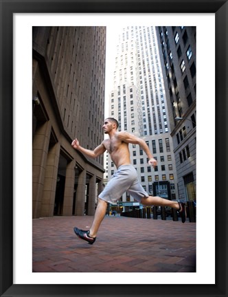 Framed Side profile of a young man running in a city Print