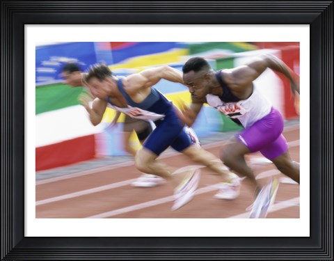 Framed Side profile of three men running low on a running track Print