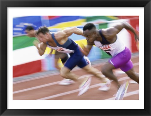 Framed Side profile of three men running low on a running track Print